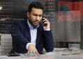 I need you to call me immediately. Shot of a young male stock broker making a frustrated phone call from his office.