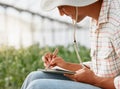 I know just what to plant next. Shot of a young man writing notes while working in a greenhouse on a farm. Royalty Free Stock Photo