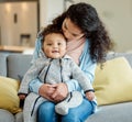 To be so complete. Shot of a young mother bonding with her baby boy on the sofa at home. Royalty Free Stock Photo