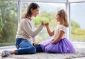 This promise will never be broken. Shot of a young mother and daughter making a pinky promise at home.