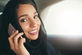 Executive business demands executive travel. Shot of a young muslim businesswoman using her phone while traveling in a Royalty Free Stock Photo