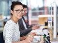 Make creativity a job. Shot of a young office worker sitting at her workstation in an office. Royalty Free Stock Photo