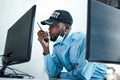 Your direct connection to first rate protection. Shot of a young security guard using a two way radio while monitoring Royalty Free Stock Photo