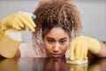 Cleaning a counter takes a lot of focus. Shot of a young woman cleaning a countertop at home. Royalty Free Stock Photo