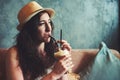 Sipping on something sweet. Shot of a young woman enjoying a chilled coffee beverage while on vacation.