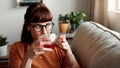 Im just sipping my tea and minding my business. Shot of a young woman enjoying a cup of tea while relaxing at home.