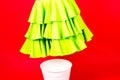 Shot of a young woman hand throwing her outwear dress in the trash isolated on red background Royalty Free Stock Photo