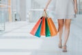 shot of young woman leg carrying colorful shopping bags Royalty Free Stock Photo