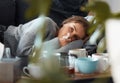 Days like this are the worst. Shot of a young woman lying on her couch blowing her nose and looking depressed. Royalty Free Stock Photo