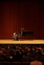 Playing for the crowd. Shot of a young woman playing the piano during a musical concert.