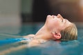 Cool the body, calm the mind. Shot of a young woman relaxing in the pool at a spa. Royalty Free Stock Photo