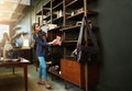 Browsing the latest in leatherwork trends. Shot of a young woman shopping in a leatherwork store. Royalty Free Stock Photo