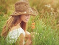 Find beauty in the smallest moments. Shot of a young woman sitting in a field in the countryside. Royalty Free Stock Photo