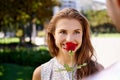 The sweet smell of love. Shot of a young woman smelling a rose her boyfriend is giving here. Royalty Free Stock Photo