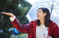 Its raining down hard. Shot of a young woman standing in the rain with an umbrella. Royalty Free Stock Photo