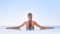 Live in the sunshine. Shot of a young woman in a swimming pool. Royalty Free Stock Photo