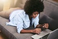 What to buy. Shot of a young woman using a laptop and credit card on the sofa at home.