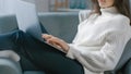 Shot of Young Woman Works on Laptop Computer while Sitting on the Chair. Sensual Girl Wearing Royalty Free Stock Photo