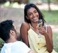 He makes my heart happy. Shot of a young woman drinking champagne while on a date at the park. Royalty Free Stock Photo
