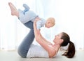 Mommy and me exercises. Shot of a young woman working out while spending time with her baby boy. Royalty Free Stock Photo