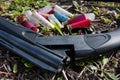 Shotgun and cartridges on the ground Royalty Free Stock Photo