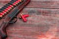 Shotgun and cartridges in patronage are lying on a wooden table top view. The hunting period, the season is open Royalty Free Stock Photo