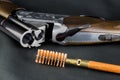 Shotgun and Cleaning Brush on a Baize Table Royalty Free Stock Photo