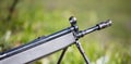 Shotgun on easel. Front side of weapon with close up view on blurred nature background. Royalty Free Stock Photo