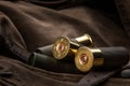 Shotgun shells close-up. Ammunition for smoothbore weapons on a khaki canvas backpack. Dark back Royalty Free Stock Photo