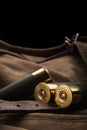 Shotgun shells close-up. Ammunition for smoothbore weapons on a khaki canvas backpack. Dark back Royalty Free Stock Photo