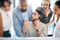 Should we go ahead. a young call centre agent sitting in the office and talking to his manager while his colleagues Royalty Free Stock Photo