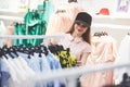 We should look at new dresses. Two beautiful girls are looking for clothes in the store. Good day for shopping Royalty Free Stock Photo