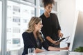 Should we reschedule this meeting. two businesswomen working together in an office.