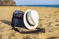 Shoulder bag and white hat on the sand of the beach Royalty Free Stock Photo