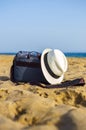 Shoulder bag and white hat on the sand of the beach Royalty Free Stock Photo