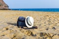 Shoulder bag and white hat on the sand of the beach Royalty Free Stock Photo