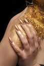 On the shoulder, fingers with golden manicure Royalty Free Stock Photo