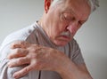 Shoulder joint pain on an older man Royalty Free Stock Photo