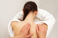 Shoulder massage for a young woman sitting on a chair. The view from the back. No face Royalty Free Stock Photo