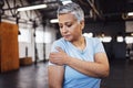 Shoulder pain, fitness and senior woman at gym in training, workout or lose weight exercise with health risk. Injury Royalty Free Stock Photo