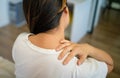 Woman with pain in her neck and shoulder and injury. Health care and medical concept.