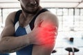 Shoulder pain, sport injury and man with fitness, muscle tension and hand, gymnast at gym and red overlay. Sports