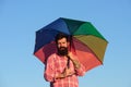 Shoulder portrait of gay man, homosexual male holding rainbow umbrella, colored in rainbow colors. LGBT movement, gay