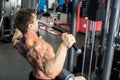 Shoulder pull down machine. Fitness man working out lat pulldown training at gym. Upper body strength exercise for the