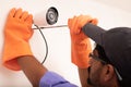 Shoulder shot of Electric Technician man setup cctv camera security system on wall - Electrician installing video