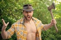 shouting angry lumberjack with axe wearing checkered shirt. angry lumberjack with axe Royalty Free Stock Photo