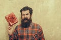 Shouting bearded man with red gift box with bow