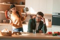 Shouting at each other, quarrel. Young couple is on the kitchen together