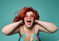 Shouting laughing loud overweight fat woman holds her head with hands can`t believe huge discount sale or crazy luck Royalty Free Stock Photo