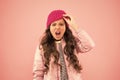 Shouting little girl pink background. kid puffer jacket and knitted hat. winter shopping. how to dress warm in winter Royalty Free Stock Photo